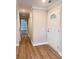 Inviting foyer with a front door with glass and hardwood floors and a view into the living room at 1425 Risher Mountain Rd, Walterboro, SC 29488
