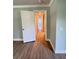 Hallway features wood-look floors, white doors, and light-colored walls at 1425 Risher Mountain Rd, Walterboro, SC 29488