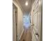 Hallway with wood-look floors leading to the living area with ceiling fan at 1425 Risher Mountain Rd, Walterboro, SC 29488