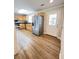 Bright kitchen with stainless steel refrigerator, wood cabinets, and adjacent door at 1425 Risher Mountain Rd, Walterboro, SC 29488
