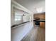 Eat-in kitchen with wooden cabinets, black appliances, and a view into the spacious living room, with hardwood floors at 1425 Risher Mountain Rd, Walterboro, SC 29488