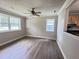 Spacious living room with multiple windows for natural light flows into the kitchen with hardwood floors at 1425 Risher Mountain Rd, Walterboro, SC 29488
