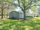 View of the back side of the home showing a fenced yard and screened in back porch at 1425 Risher Mountain Rd, Walterboro, SC 29488
