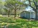 View of the yard showing mature trees, grass and view of the side of the home at 1425 Risher Mountain Rd, Walterboro, SC 29488