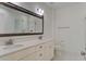 Bright bathroom featuring a double sink vanity, decorative mirrors and a glass-enclosed shower at 148 Cowrie Ct, Mount Pleasant, SC 29464