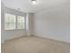An empty bedroom with neutral carpet and two windows provides a serene, light-filled space at 148 Cowrie Ct, Mount Pleasant, SC 29464