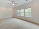 Spacious bedroom with neutral carpet, fan and three large windows offering ample natural light at 148 Cowrie Ct, Mount Pleasant, SC 29464