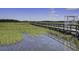 A wooden boardwalk stretches across a marsh, providing a scenic walking path at 148 Cowrie Ct, Mount Pleasant, SC 29464