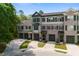 The townhome boasts a well-maintained front exterior with garages and charming brick and siding details at 148 Cowrie Ct, Mount Pleasant, SC 29464