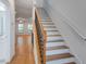 Hallway with hardwood floors and a staircase leading to the upper level, with a view of living room at 148 Cowrie Ct, Mount Pleasant, SC 29464