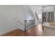 Bright hallway features hardwood floors and a staircase with wood and iron railings at 148 Cowrie Ct, Mount Pleasant, SC 29464