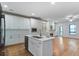 Open floor plan showcasing a modern kitchen island flowing into the dining area, perfect for entertaining at 148 Cowrie Ct, Mount Pleasant, SC 29464