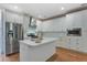Modern kitchen with stainless steel appliances, a center island, and white cabinets for a sleek, updated look at 148 Cowrie Ct, Mount Pleasant, SC 29464
