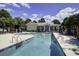 Beautiful community pool with lounge chairs, umbrella tables, and a clear view of the clubhouse on a bright day at 148 Cowrie Ct, Mount Pleasant, SC 29464