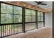 Relaxing screened porch with wood flooring, string lights and wooded view, perfect for outdoor enjoyment at 148 Cowrie Ct, Mount Pleasant, SC 29464