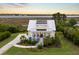Stunning aerial view of a two-story home with a metal roof, lush yard, and waterfront property at 1500 Bower Ln, Johns Island, SC 29455