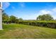 Well-manicured backyard with lush green grass, mature landscaping, and a fire pit area at 1500 Bower Ln, Johns Island, SC 29455
