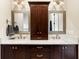 Bathroom with granite counters, dual sinks, and wood cabinets with brushed nickel hardware at 1500 Bower Ln, Johns Island, SC 29455