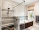 This bathroom features tile flooring, a glass shower, and a soaking tub with a view at 1500 Bower Ln, Johns Island, SC 29455