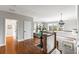 This foyer has a hardwood floor, a staircase with white railings, and a view of the living room at 1500 Bower Ln, Johns Island, SC 29455