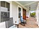 Inviting front porch with rocking chairs and a swing, perfect for enjoying the outdoors at 1500 Bower Ln, Johns Island, SC 29455
