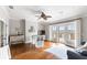 This living room has hardwood floors, white walls, a ceiling fan, and access to a deck overlooking the water at 1500 Bower Ln, Johns Island, SC 29455