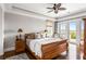 This main bedroom has hardwood floors, a ceiling fan, and access to a deck overlooking the water at 1500 Bower Ln, Johns Island, SC 29455