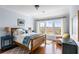 This bedroom has light blue walls, hardwood floors, and a large window with a view of the water at 1500 Bower Ln, Johns Island, SC 29455