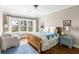 This bedroom has hardwood floors, white walls, and a large window with a view of the water at 1500 Bower Ln, Johns Island, SC 29455