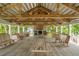 Large wooden pavilion with picnic tables, ceiling fans, and a fireplace at 1500 Bower Ln, Johns Island, SC 29455