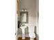 Charming powder room with pedestal sink, decorative mirror, and stylish fixtures at 1500 Bower Ln, Johns Island, SC 29455