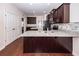 Modern kitchen boasts granite countertops, a center island, stainless steel appliances, and dark wood cabinets at 151 Kirkland St, Goose Creek, SC 29445