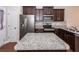 Functional kitchen with granite island, stainless steel appliances, mosaic tile backsplash, and wood flooring at 151 Kirkland St, Goose Creek, SC 29445