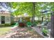 Spacious backyard with dining and lounging areas under mature trees at 1575 Langston Dr, Johns Island, SC 29455