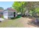 The backyard features a charming shed, seating area and well-maintained greenery at 1575 Langston Dr, Johns Island, SC 29455