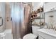 Standard bathroom with a shower curtain, toilet, and storage shelves at 1575 Langston Dr, Johns Island, SC 29455