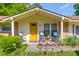 Inviting front porch with cheery yellow door and rocking chairs, perfect for relaxing outdoors at 1575 Langston Dr, Johns Island, SC 29455