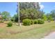 View of the spacious front yard with mature trees and well-maintained landscaping at 1575 Langston Dr, Johns Island, SC 29455