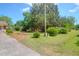 Spacious front yard with mature trees and landscaping, offering privacy at 1575 Langston Dr, Johns Island, SC 29455