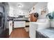 A quaint kitchen with white cabinets, dark countertops, and appliances, plus a washer and dryer at 1575 Langston Dr, Johns Island, SC 29455