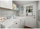 Well-lit laundry room with a door to the outside and overhead storage at 1616 Refuge Run, Charleston, SC 29412