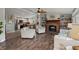 Open-concept living space with a fireplace and a view of the kitchen and island with seating at 1616 Refuge Run, Charleston, SC 29412