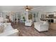 Spacious living room with hardwood floors, a fireplace, and views into the dining and kitchen areas at 1616 Refuge Run, Charleston, SC 29412