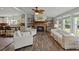 Cozy living room with a fireplace, built-in bookshelves, and light-filled windows, creating a warm and inviting space at 1616 Refuge Run, Charleston, SC 29412