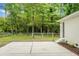 This backyard features a concrete patio and mature trees at 1621 Point Park Dr, Johns Island, SC 29455