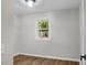 This bedroom has wood flooring, a neutral color palette, and a large window at 1621 Point Park Dr, Johns Island, SC 29455