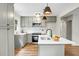 Modern kitchen with gray cabinets, stainless steel appliances, and a stylish island with a sink at 1621 Point Park Dr, Johns Island, SC 29455
