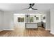 Open-concept living space with wood floors, a modern kitchen, and ample natural light for seamless living at 1621 Point Park Dr, Johns Island, SC 29455