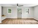 Bright and airy living room with wood floors, natural light, and a modern ceiling fan at 1621 Point Park Dr, Johns Island, SC 29455