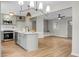 Stylish living area open to a modern kitchen, featuring wood floors and contemporary lighting fixtures at 1621 Point Park Dr, Johns Island, SC 29455